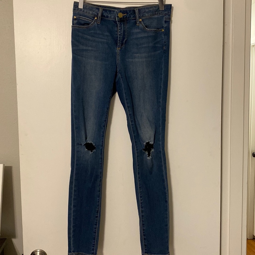 Medium wash jeans with ripped knee